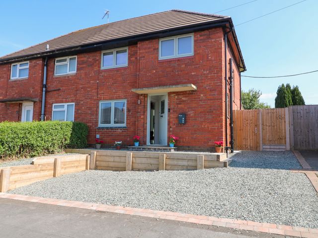 A house with a front door and planters at 19 Berry Avenue Breedon On The Hill