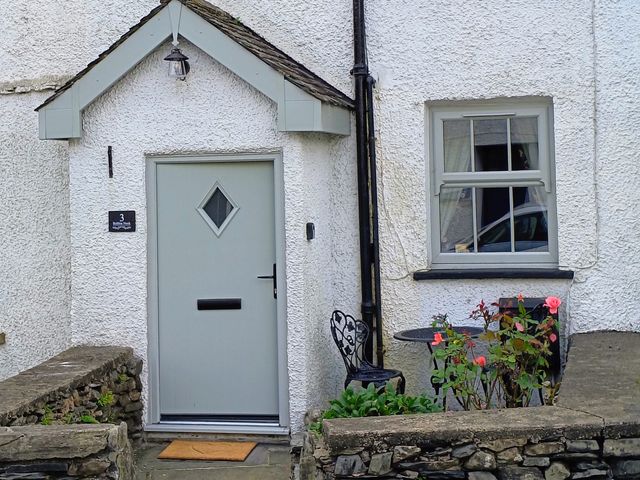 An entrance with a door and flowers at Bobbin Nook in Staveley
