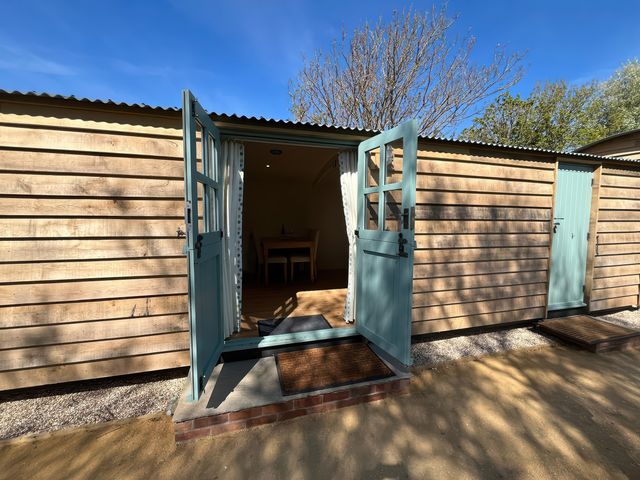 An outdoor entrance with opened doors leading to a room at The Orchard in Ringstead