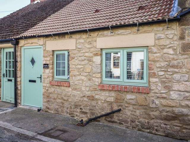 A cottage exterior with a door and windows at 2 Low Road