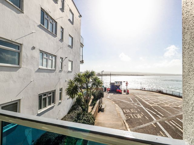 A view of a building and sea from a window at Flat 17 Golden Gates in Poole