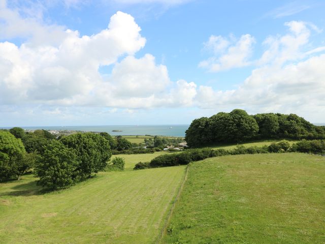 A view of trees and fields overlooking the sea at Glynllifon 8 Marian-glas near Benllech