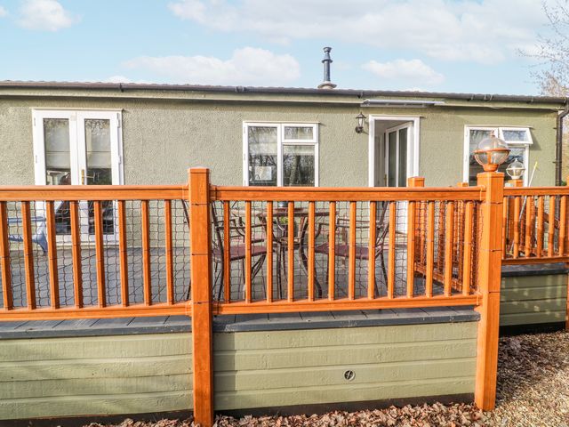 An outdoor area with a wooden deck and seating at The Nest Lodge 55 Grantham