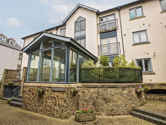 A glass extension with a garden area and stone wall at 6 Dartmouth House, Dartmouth