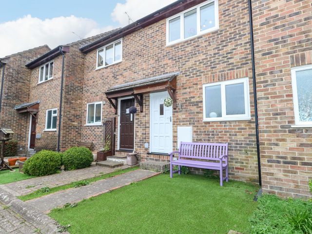 An outdoor area with a brick exterior and a purple bench at Amber House in Dorchester