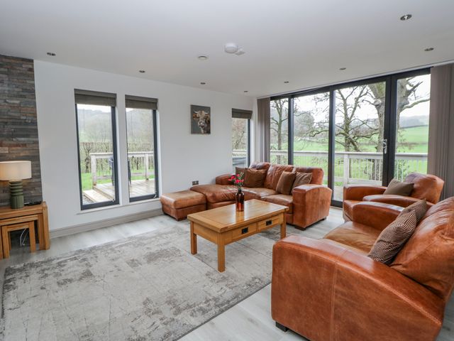 A living room with a sofa and coffee table at Oak Lodge in Knighton