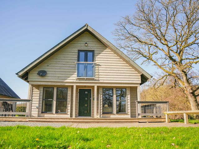 A house with a balcony and windows at Oak Lodge in Llangunllo