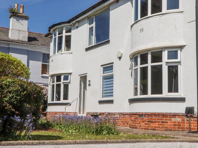 A house with multiple windows and a brick exterior at The Arches in Torquay