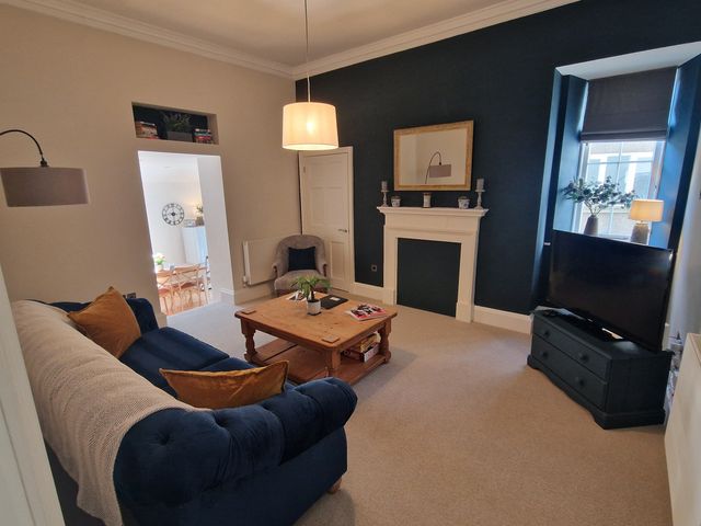 A living room with a sofa and table at Flat 3 in Ross-on-Wye
