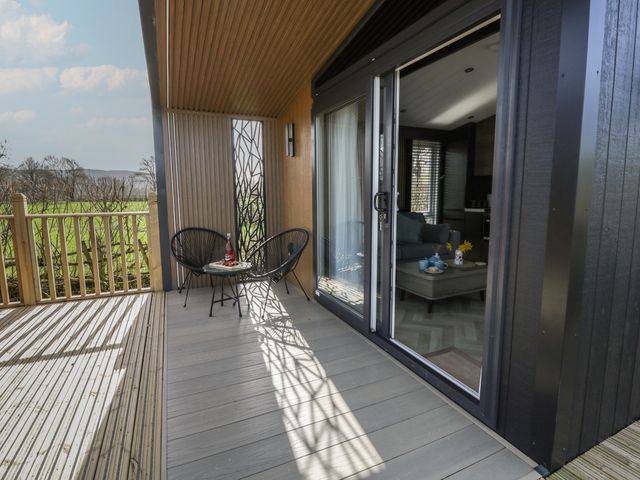 A deck with a table and chairs at Dawn's Rest Nantmel near Rhayader
