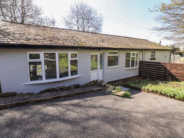 An outdoor view of a house with windows and a door at Beacon Fell Cottage 1 Preston