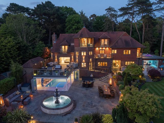 A house with a swimming pool and outdoor seating at Hamble House in Warsash