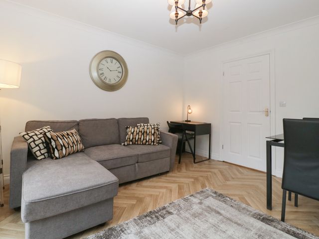 A living room with a sofa and desk at 42 Ynys Y Nos in Glynneath