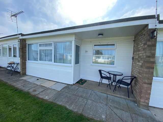 A patio area with table and chairs at Chalet 57 in California, Norfolk