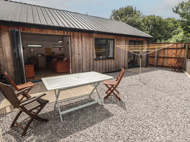 An outdoor area with a table and chairs at Brookview Goldfinch in Haverfordwest