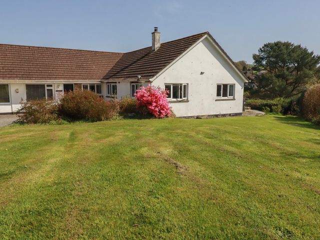 A house with a garden and flower bushes at Tregoning annex Lerryn near Lostwithiel
