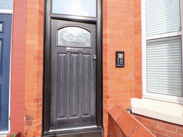 An entryway with a black door and number 18 at Seaside Home New Brighton