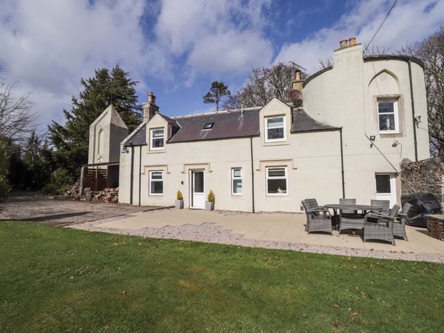 A house with a patio and garden at Craig Cottage in Banff
