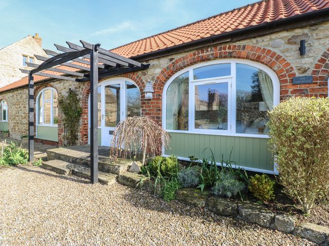An outdoor area with brick and stone structure at Castle View Cottage in Bedale