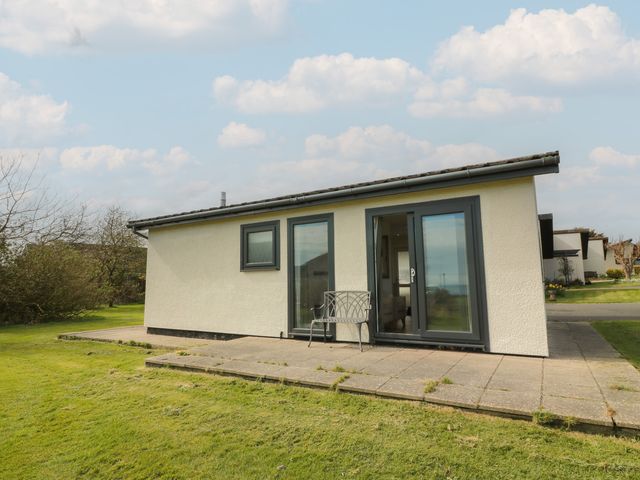 A house with patio and bench at 15 Laigh Isle 