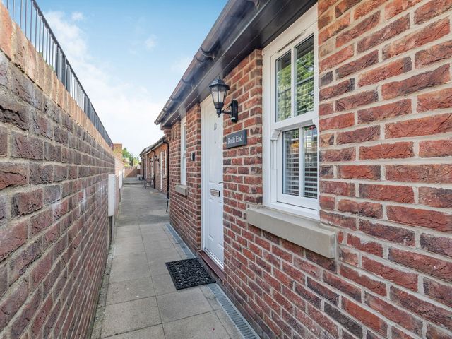 An outdoor walkway with a door and window at Rails End