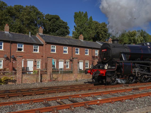 A steam locomotive near residential houses at Rails End in Whitby
