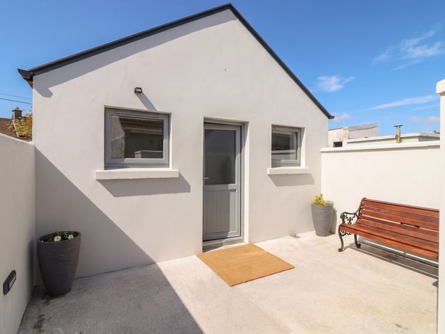 An outdoor area with a bench and plant pots at 17 ROOSKA, Lisdoonvarna, County Clare