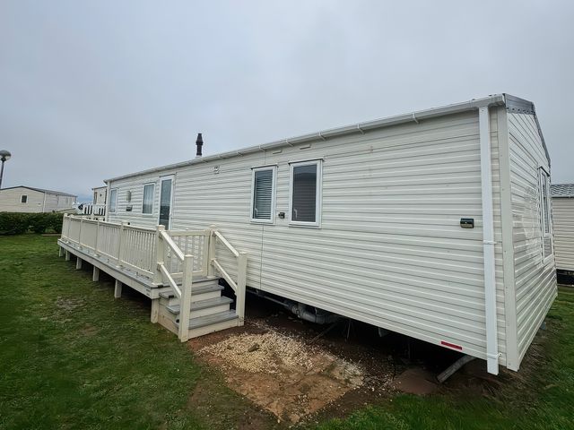 A mobile home with a deck and steps at Harbour Watch 22 Watchet