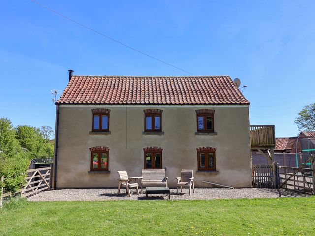 A house with chairs in the garden at The Annexe at Dalby Carr