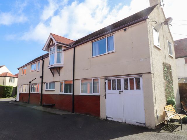 A house with windows and a garage door at The Old Stables Rhos-On-Sea