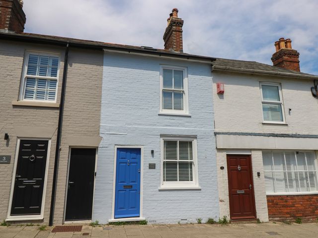 A row of houses with various colored doors at Cobblers Cottage in Lymington