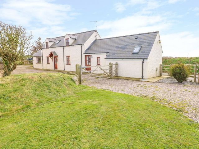 A house with a gate and grassy area at Maerdy Cwtch in Haverfordwest