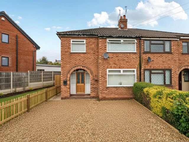 A house with a gravel driveway and fence at Village retreat with canal walk into Chester in Christleton