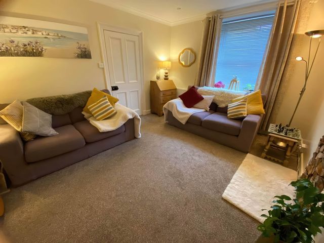 A living room with sofas and a lamp at Pet-friendly coastal flat with fire pit and views Newburgh, Fife
