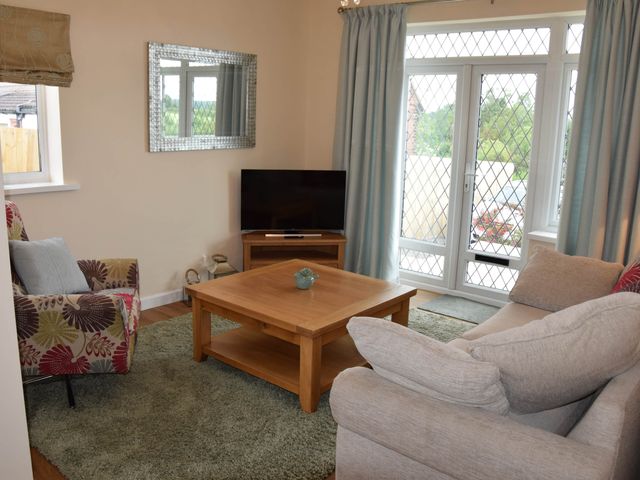 A living room with a sofa and coffee table at tbc 