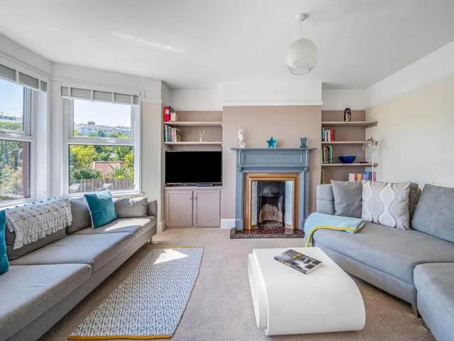 A living room with a television and bookshelves at tbc 