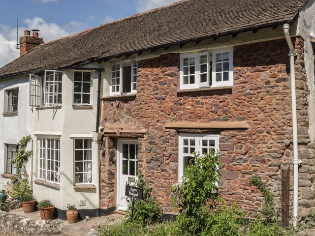 A house exterior with plants and a sign at Upper Frogpool Cottage in Crediton