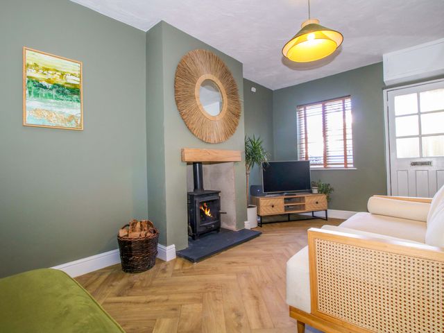 A living room with fireplace and sofa at Cheshire Views in Malpas