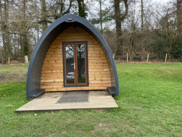 A pod with a wooden deck and a door at Bracelands - Cosy Pod 2 Coleford