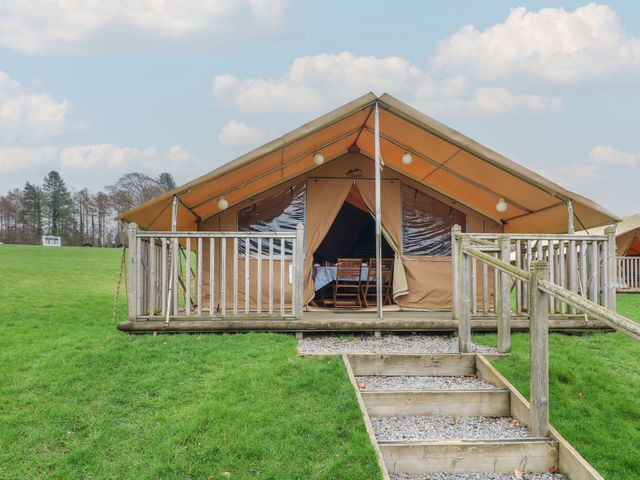 A tent with a deck and furniture at Bracelands - Safari Tent 2 near Coleford