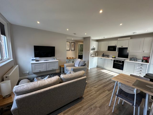 A living room with a sofa and television at The Esk in Melrose