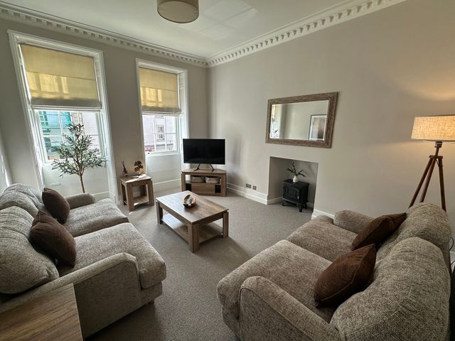 A living room with sofa and television at Horsemarket in Kelso