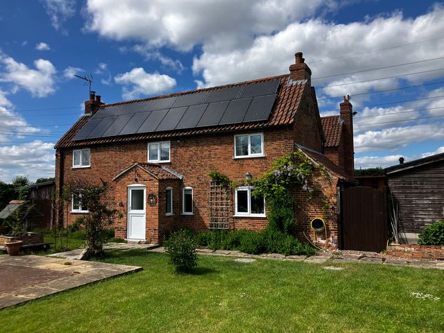 A house with solar panels and a garden at Brecks Cottage Moorhouse near Tuxford