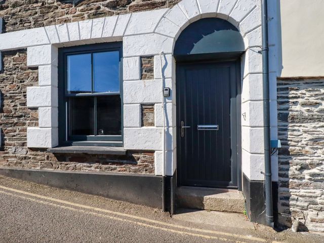 An entryway with a door and a window at Whalebone Cottage in St. Austell