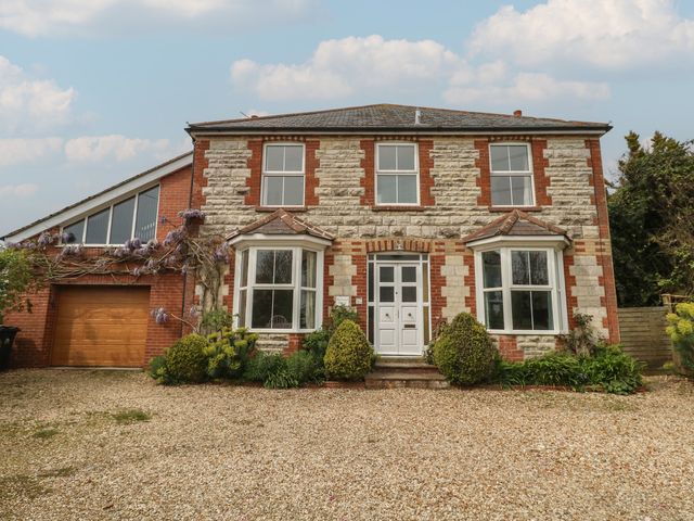 A house with garage and pathway at Millmead House in Portesham