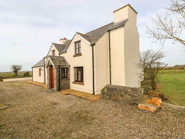 A house with a pathway and gravel at Maerdy Lodge