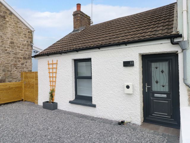 A house exterior with a door and window at Y Bwthyn in Burry Port