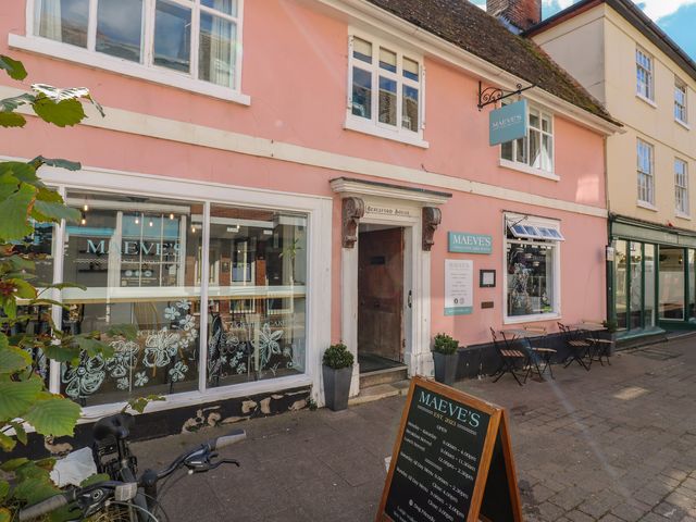 A storefront with a sign and outdoor seating at Beresford House in Woodbridge
