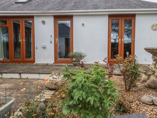 An outdoor area with doors and planters at Honeysuckle Rise in Looe