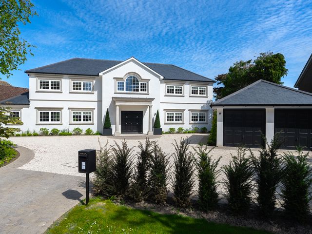 A house with a garage and pathway at Sea Estate House in Rustington